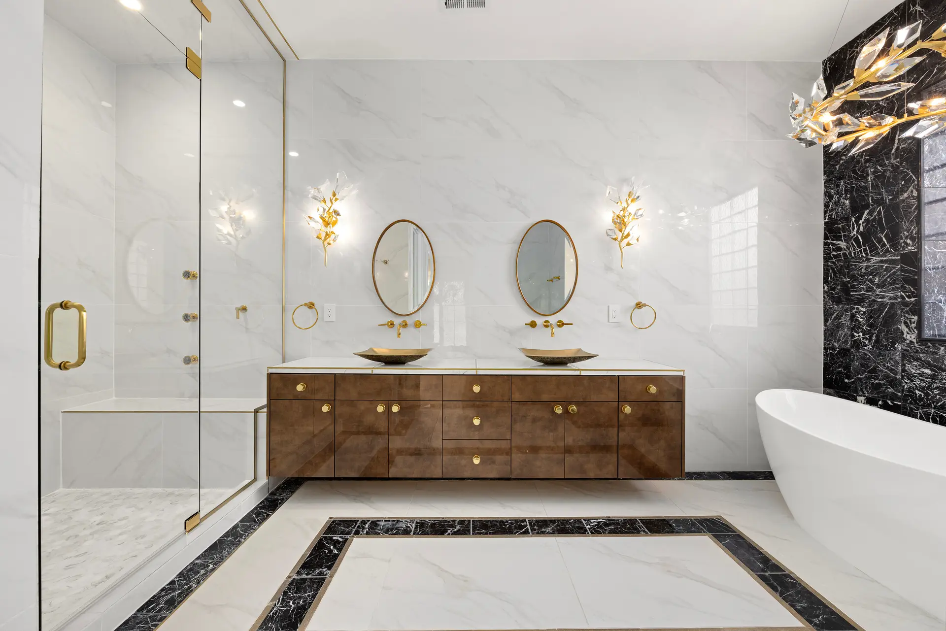 Luxury modern bathroom with double vanity, glass shower and freestanding bathtub in marble