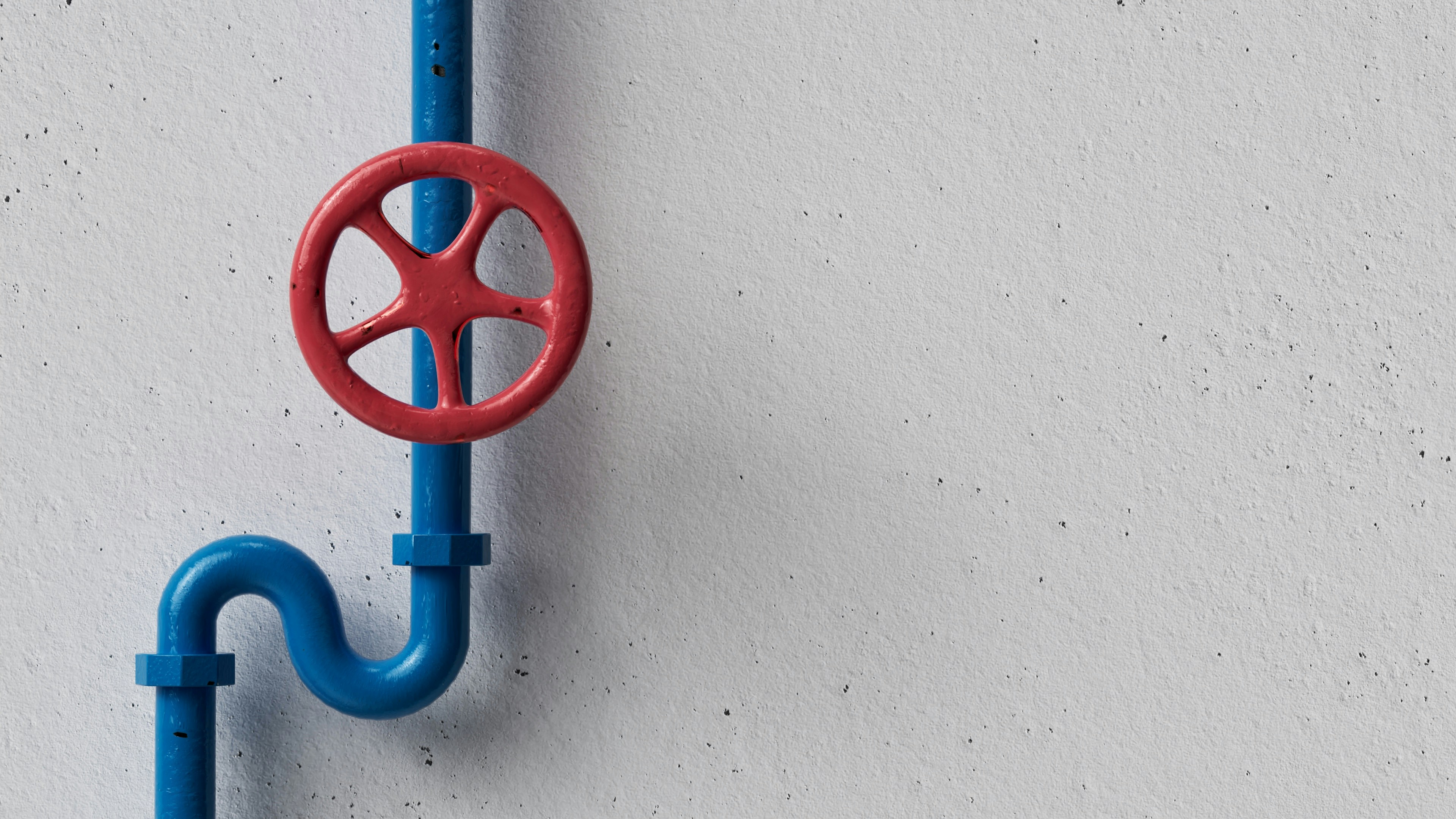 Blue pipe with red valve on white wall for plumbing system or water pipe