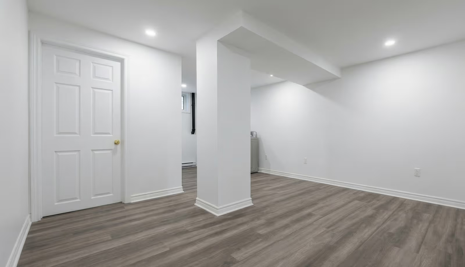 Renovated basement with modern flooring and bright white walls clean and minimalist interior space