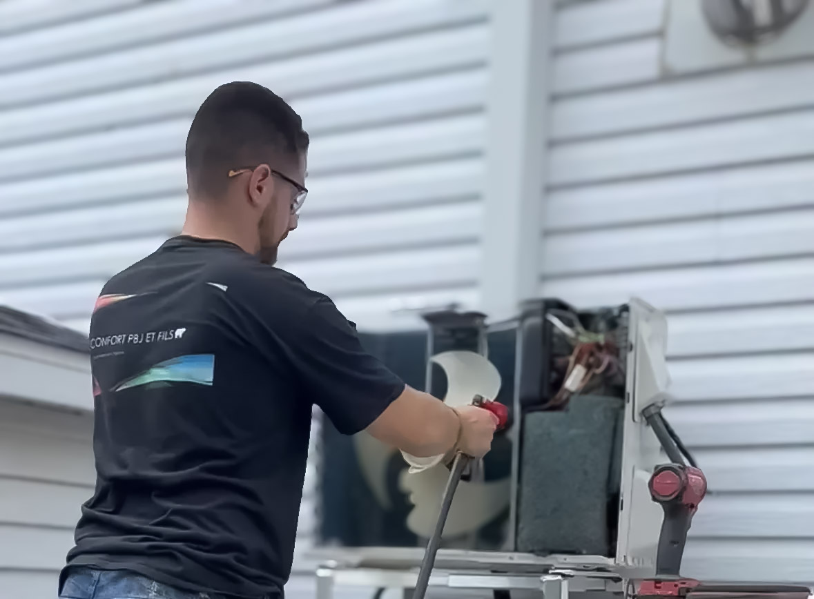 HVAC technician performing maintenance on residential outdoor heat pump unit.
