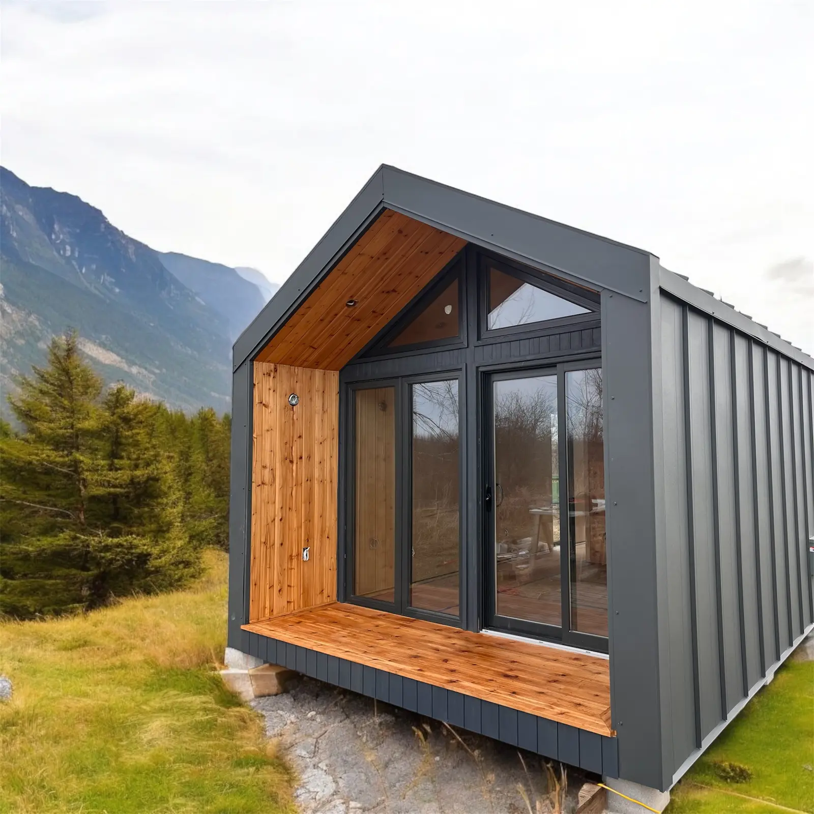Modern steel tiny house with wooden deck and large windows in natural surroundings