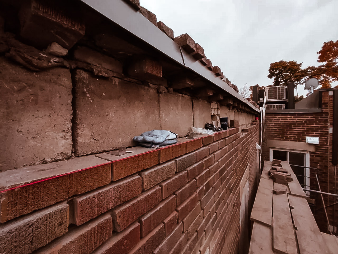 Brick wall repair with scaffolding and masonry tools.