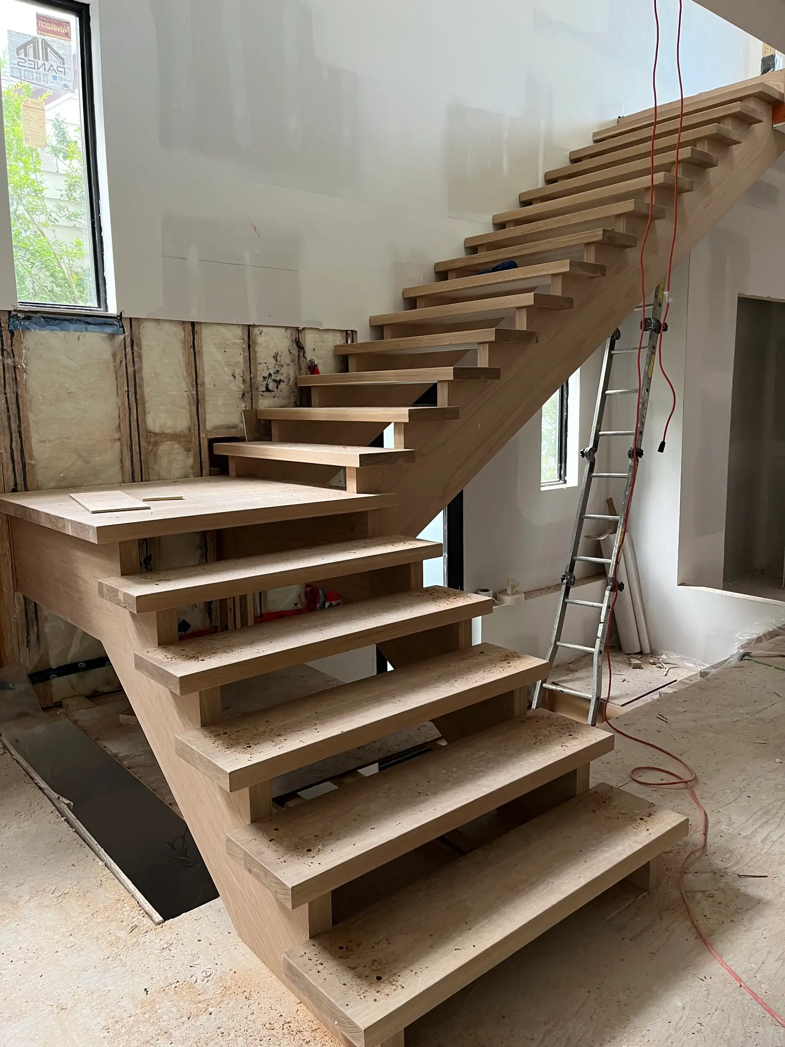 Solid wood indoor staircase under installation in a house under renovation