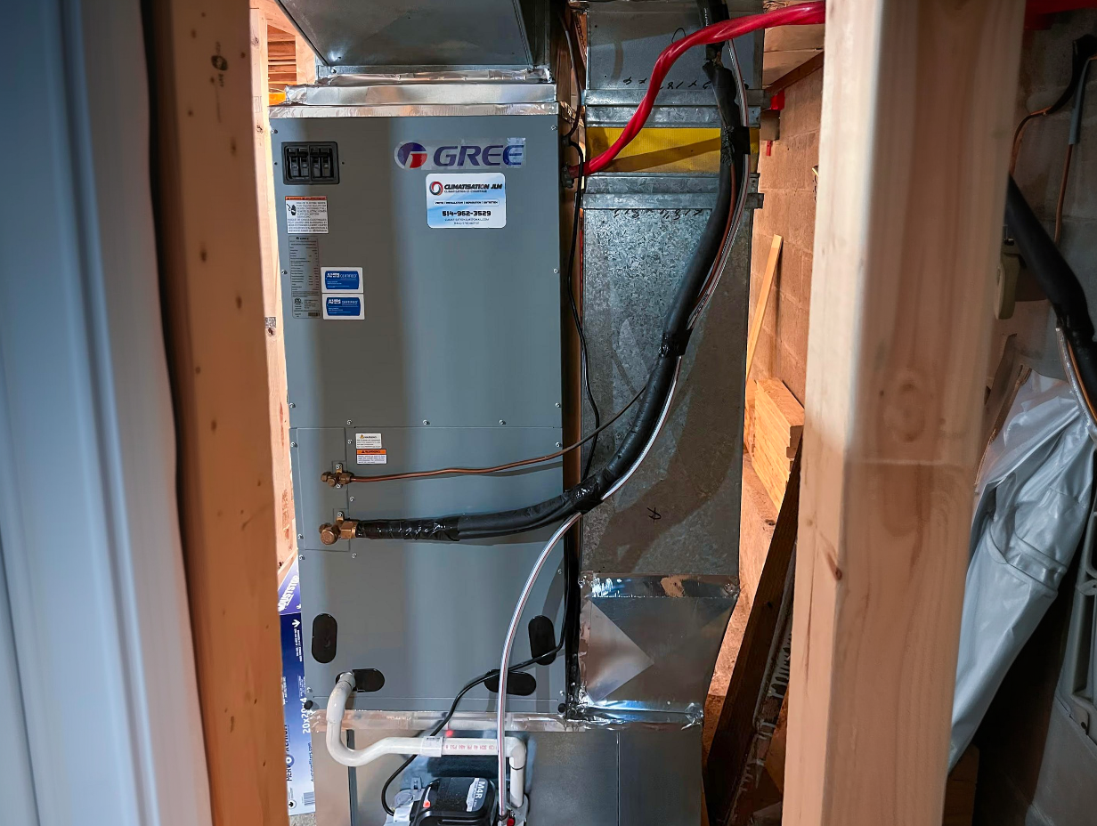 Gree residential furnace installed in a mechanical room with ventilation ducts, insulated pipes and condensate pump
