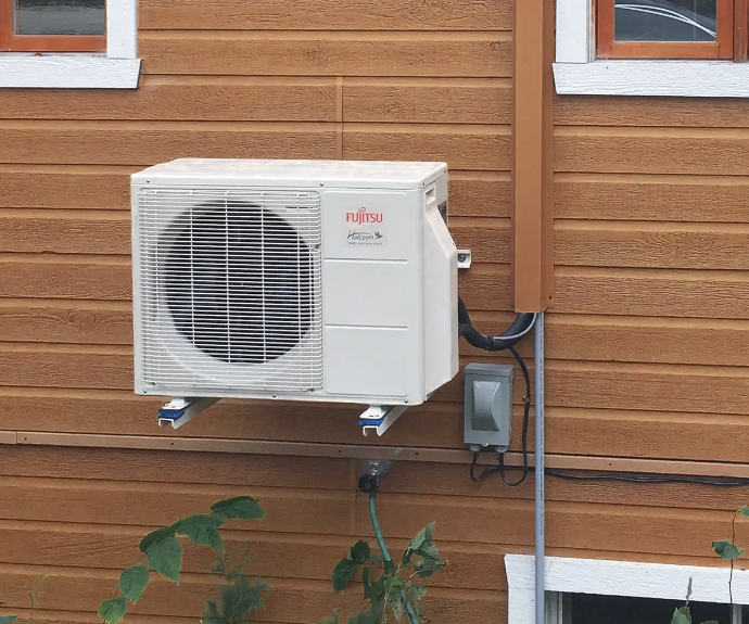Fujitsu outdoor wall unit installed on wood siding