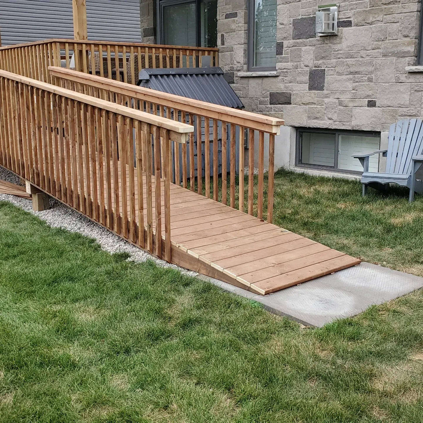 Wood accessibility ramp with guardrails providing safe and accessible residential entrance