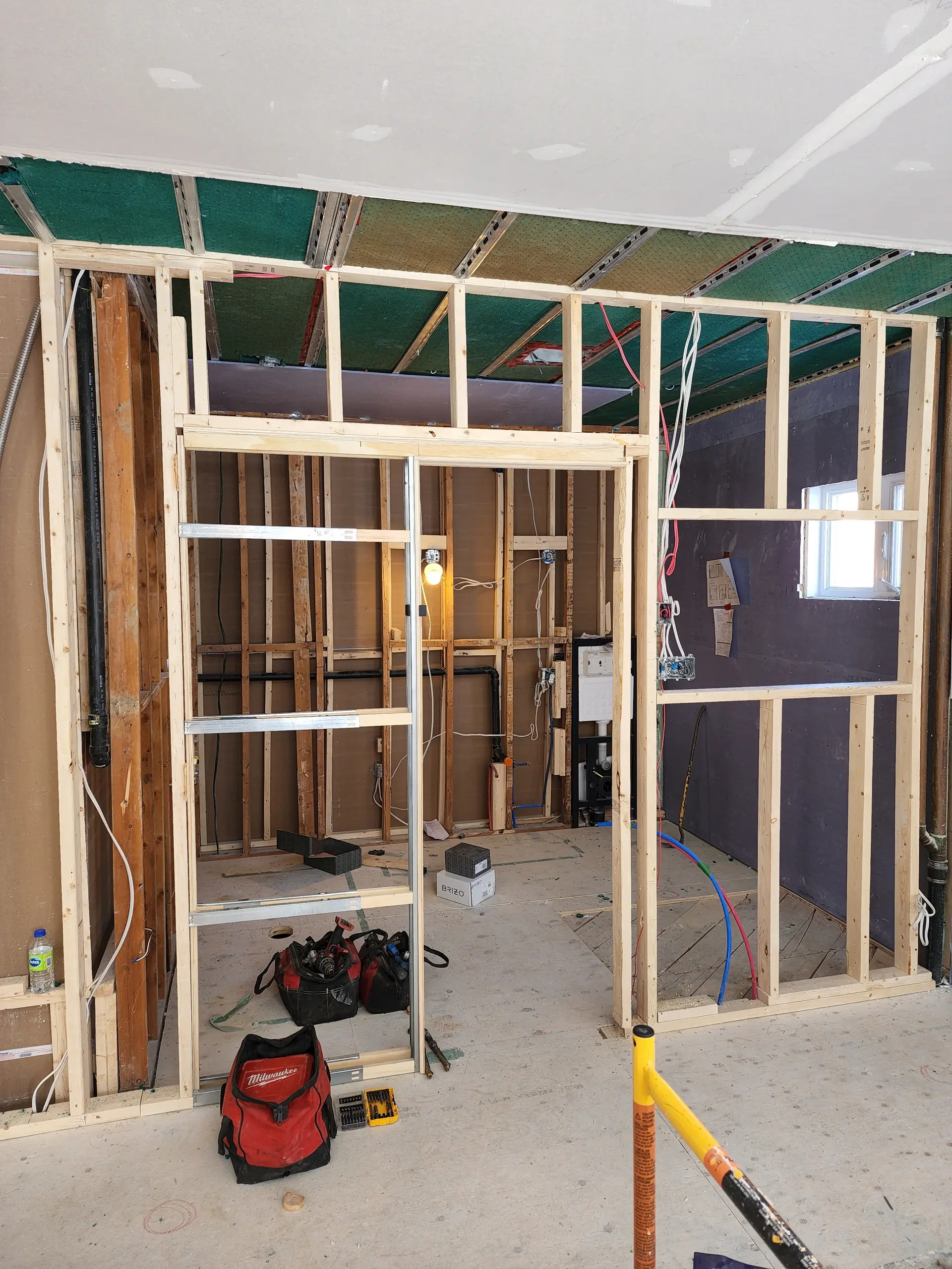 Wooden framing and electrical wiring for an interior residential renovation.